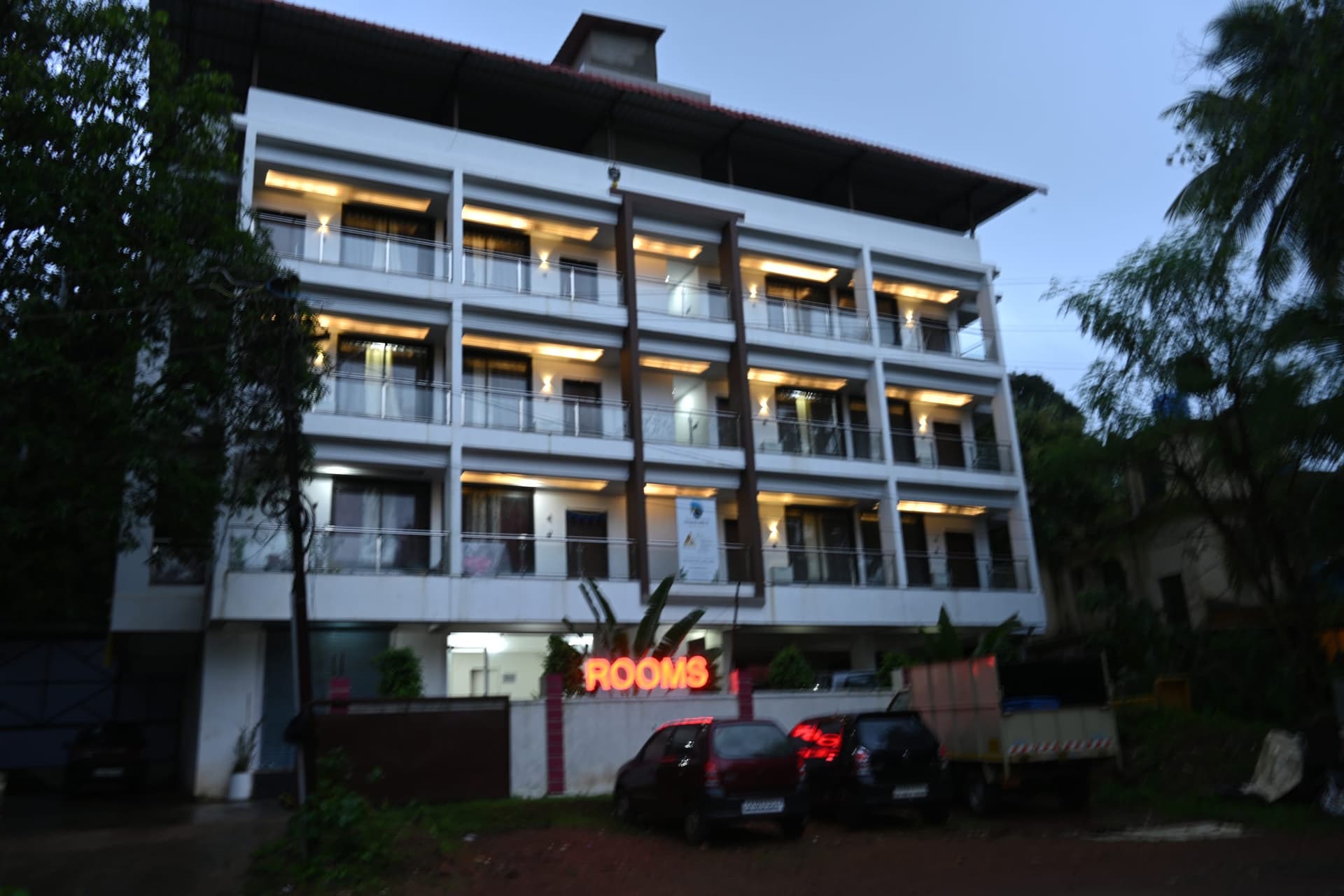 The house at dusk, every balcony lit