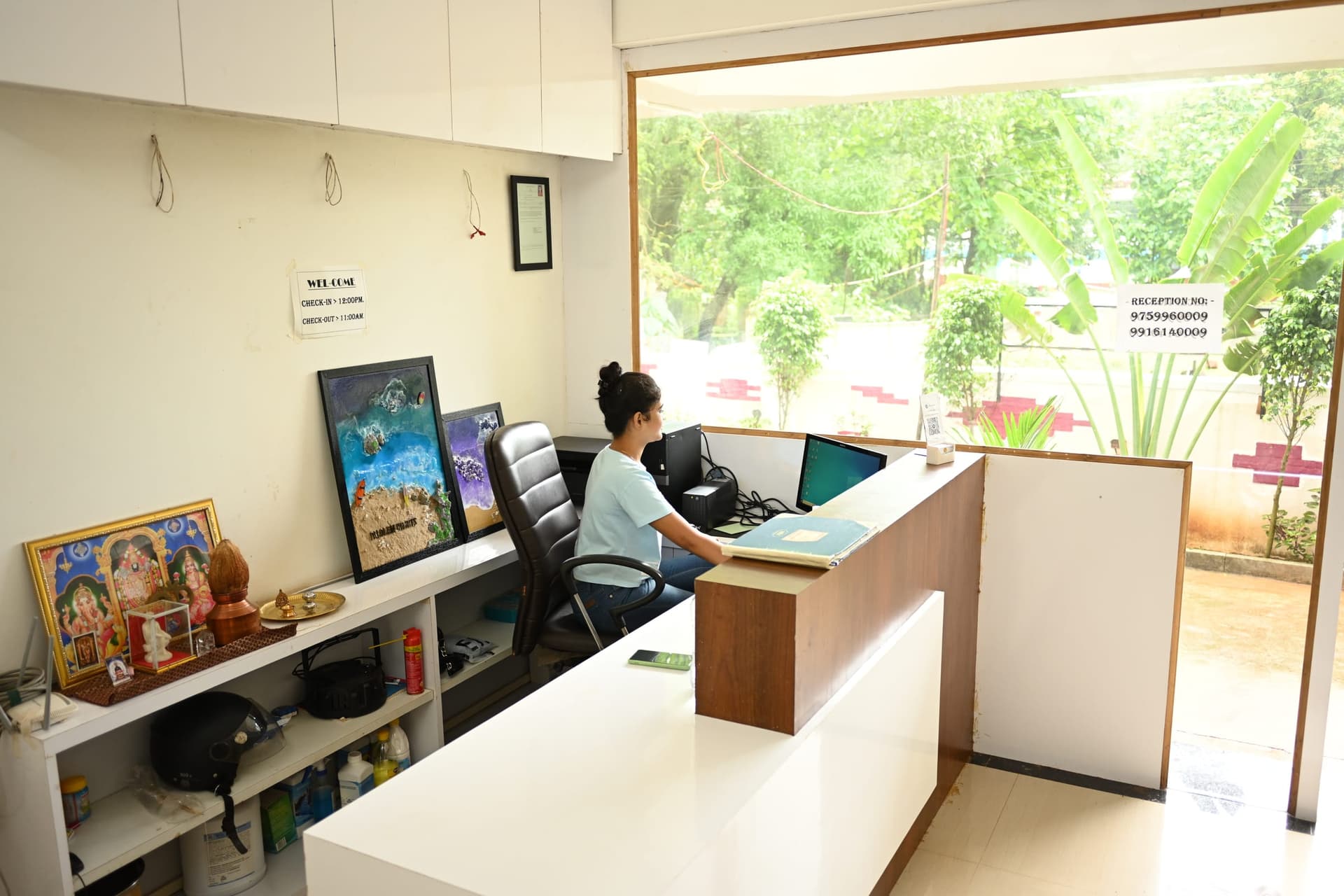 Reception — a white desk and a window on the garden
