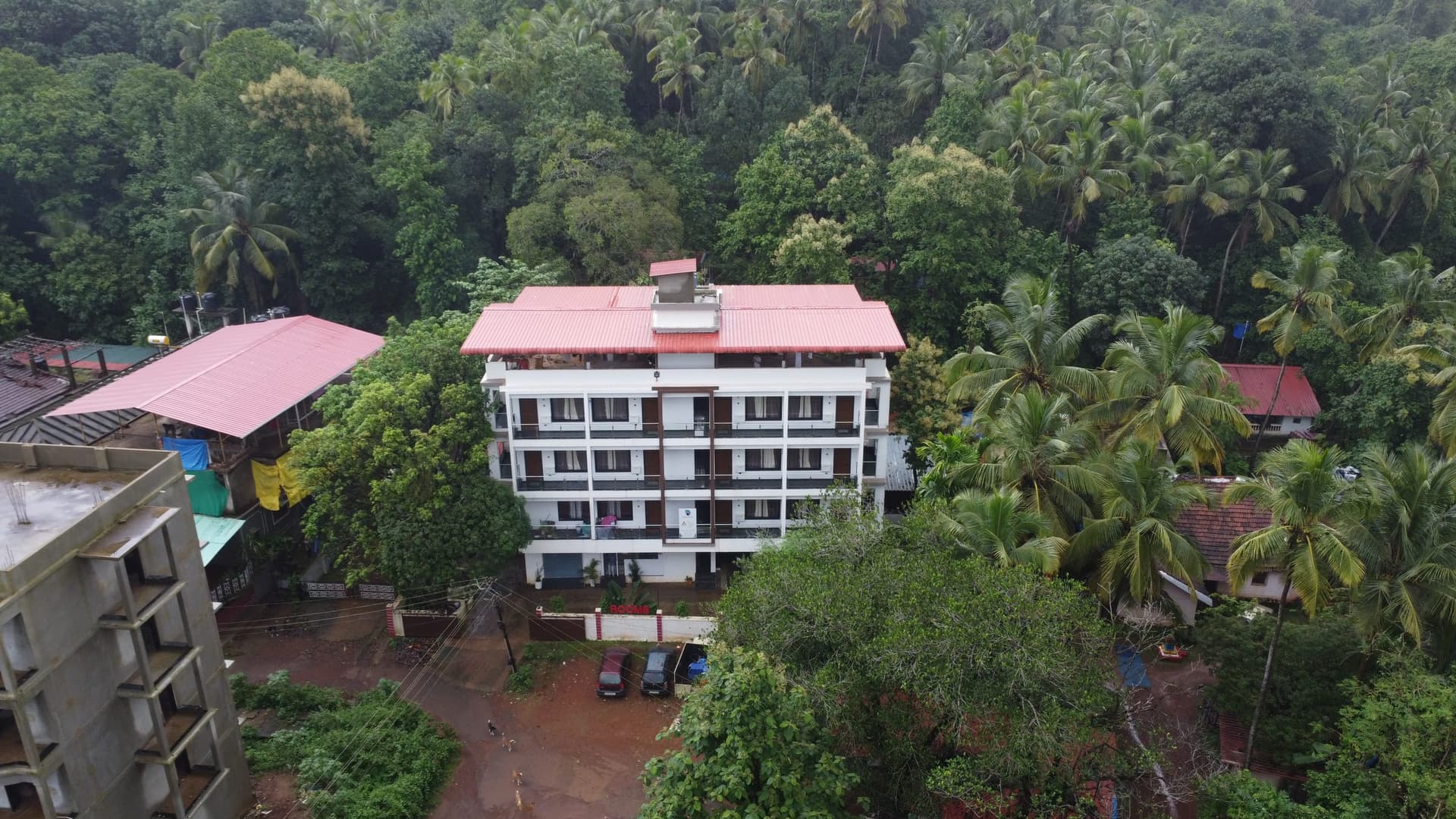 Palolem Heights from the air among the trees of Nagarcem, the lane and neighbouring roofs below