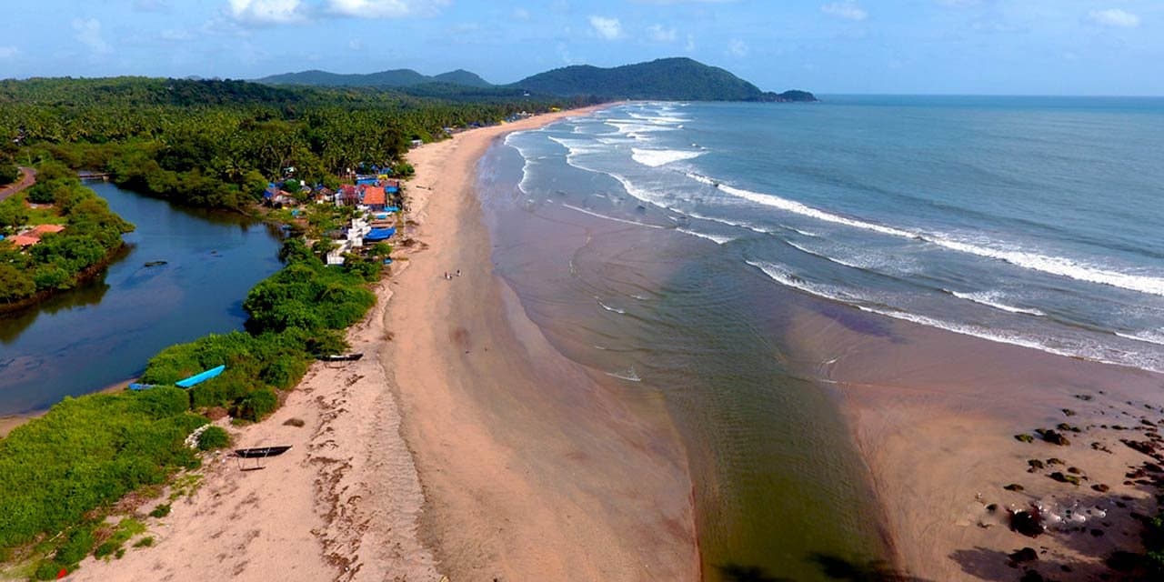 An empty stretch of golden sand and surf at Agonda, South Goa