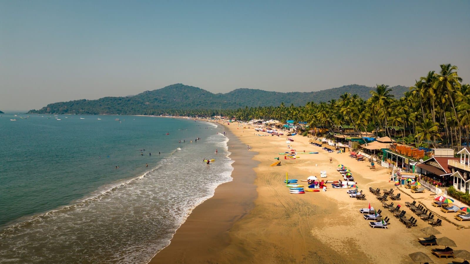 Palolem Beach from above — a crescent of sand, palms and calm sea